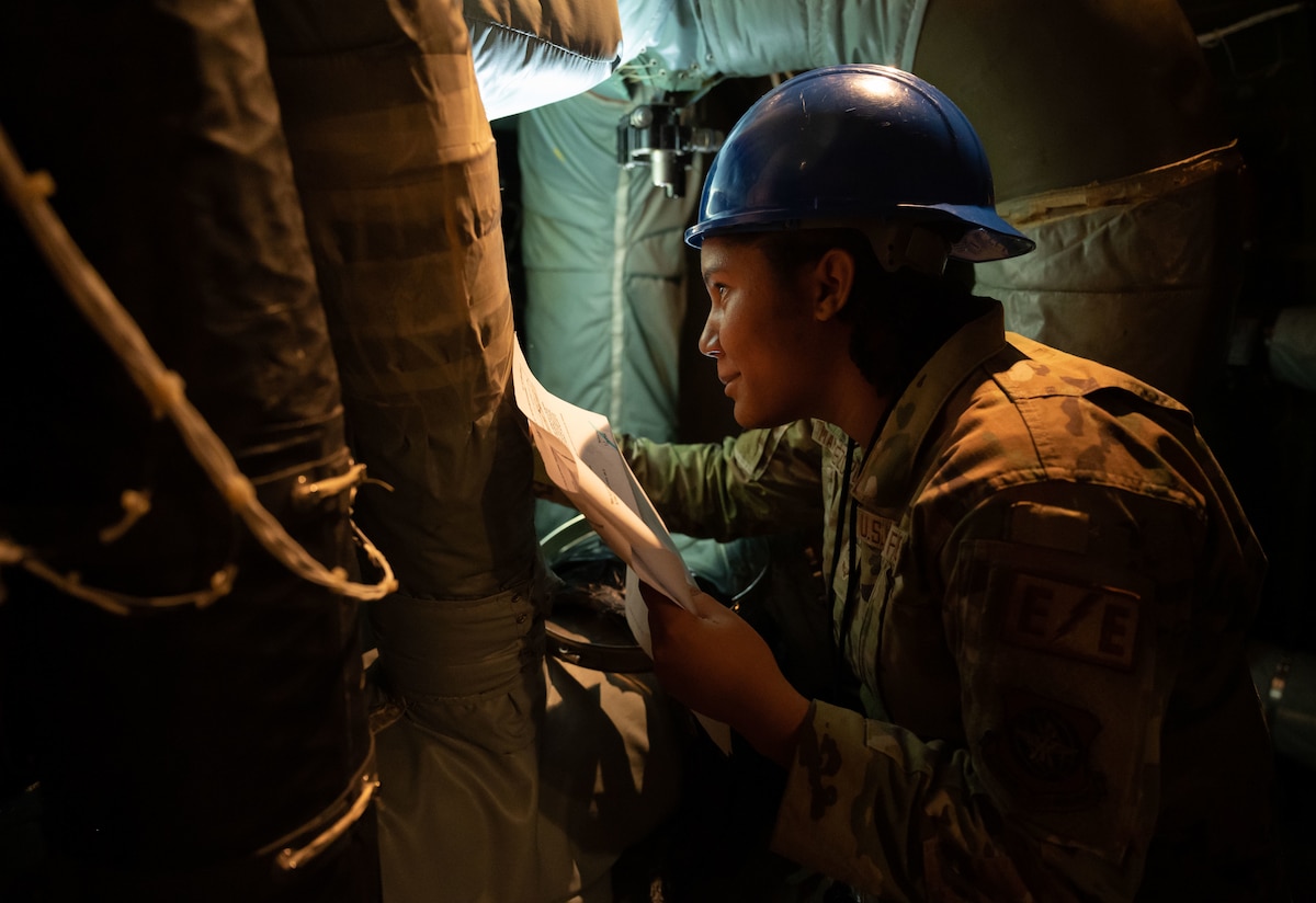 Airman 1st Class Visaury Martinez Cruz, 436th Maintenance Squadron Electrical and Environmental apprentice, inspects an air conditioning valve on a C-5M Super Galaxy at the 436th MXS Isochronal Dock on Dover Air Force Base, Delaware, March 24, 2023. The 436th MXS Isochronal Dock is capable of performing certain Programmed Depot Maintenance-level jobs, effectively minimizing maintenance downtime and increasing aircraft availability. (U.S. Air Force photo by Senior Airman Cydney Lee)