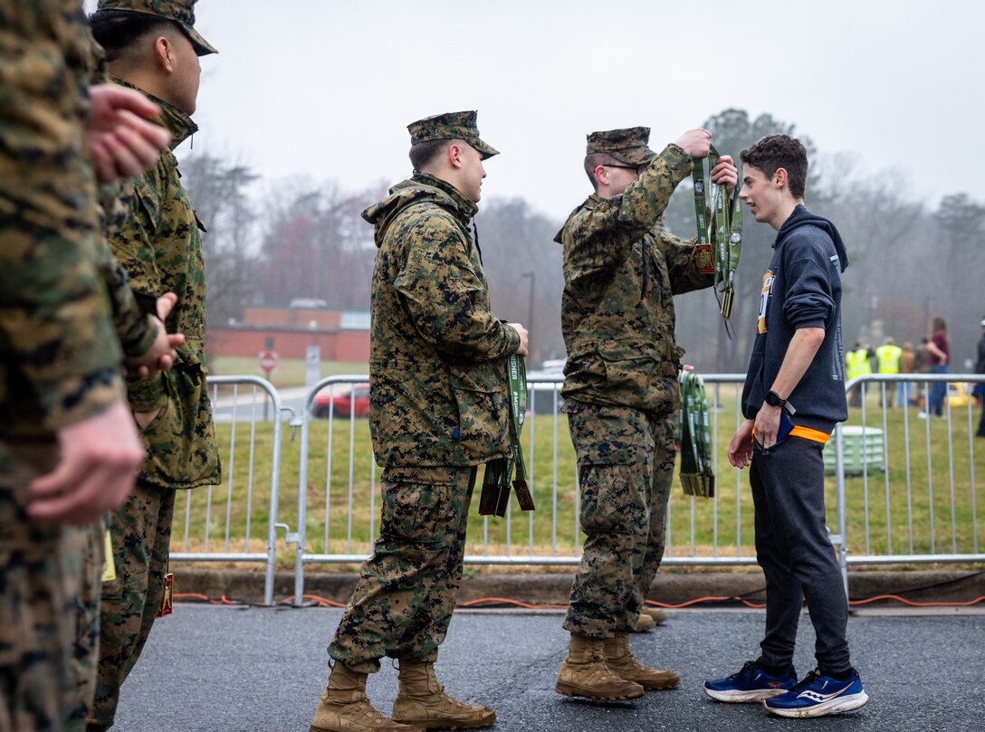 U.S. Marines with Marine Corps Base Quantico hand out medals to participants of the Marine Corps
Marathon 17.75k at Prince William Forest Park, Virginia, March 25, 2023. Finishers of this race are
guaranteed access to participate in the 48th MCM held in October. (U.S. Marine Corps photo by Lance
Cpl. Joaquin Dela Torre)