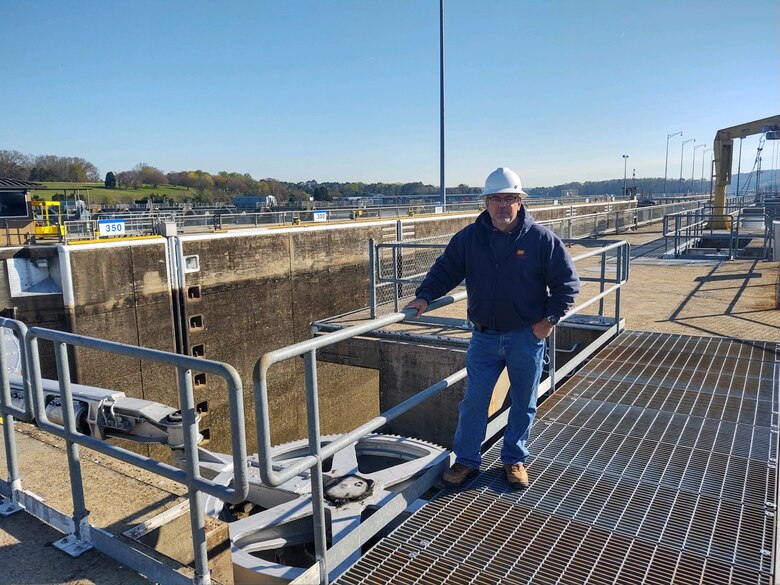 A man with a hard hat stands on top of Fort Loudoun Lock