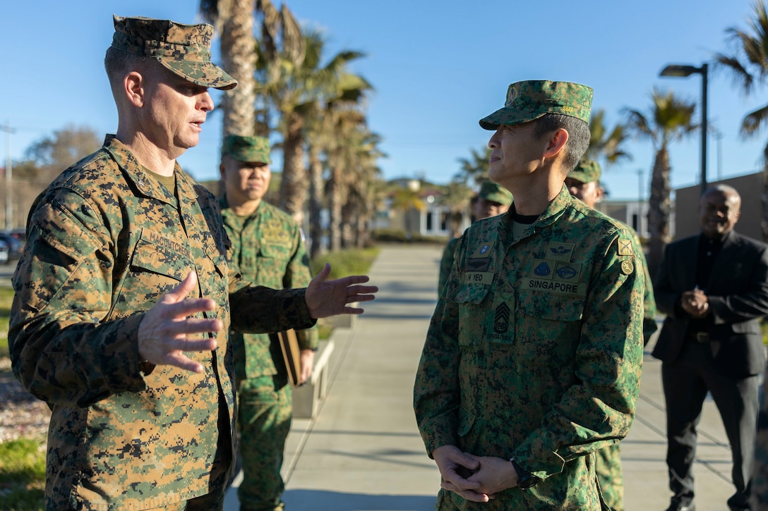U.S. Marine Corps Col. Seth MacCutcheon, commanding officer of School of Infantry - West, greets Singapore Army Chief Warrant Officer Yeo Keng Hua, sergeant major of the Singapore Army, at Marine Corps Base Camp Pendleton, California, Feb. 2, 2023. The Marine Corps is dedicated to maintaining and developing its relationship with allied nations in the Pacific. (U.S. Marine Corps photo by Lance Cpl. Fred Garcia)