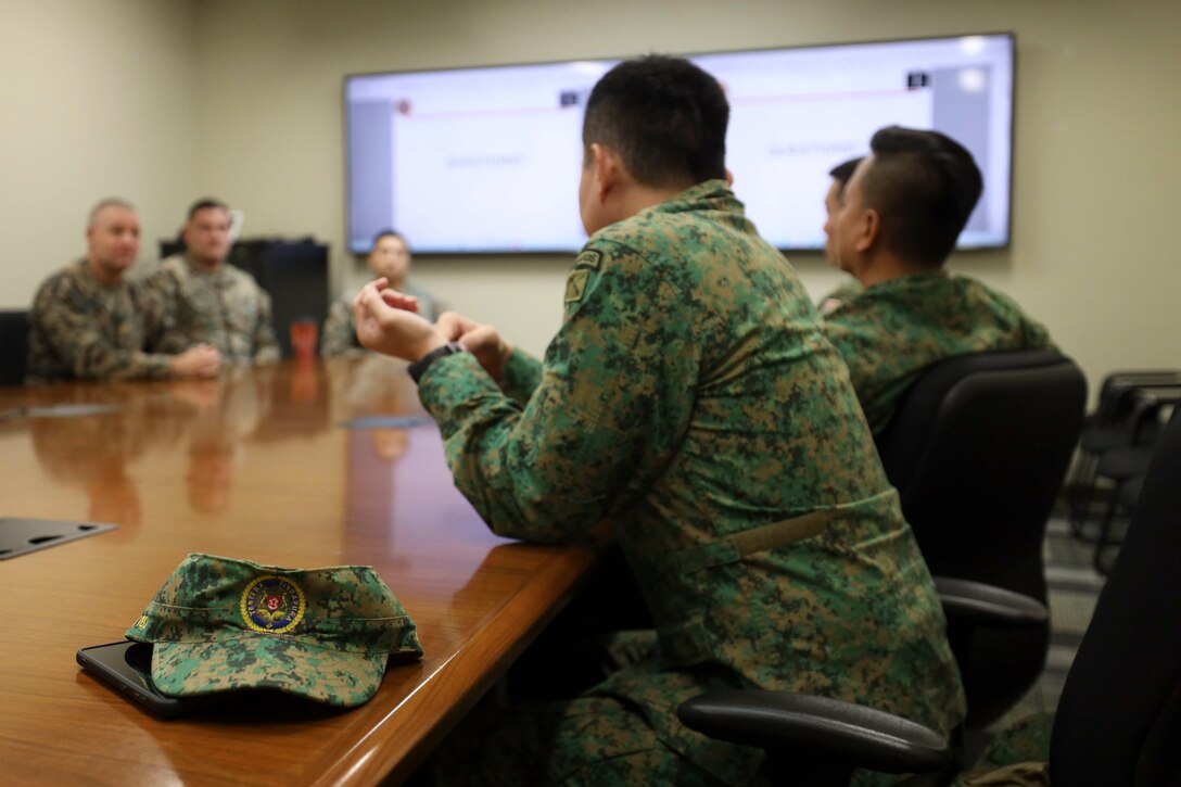 Leadership of the Singapore Army discuss U.S Marine Corps training plans and schedules with U.S. Marine Corps instructors at the School of Infantry – West at Marine Corps Base Camp Pendleton, California, Feb. 2, 2023. The Marine Corps is dedicated to maintaining and developing its relationship with allied nations in the Pacific. (U.S. Marine Corps photo by Lance Cpl. Fred Garcia)