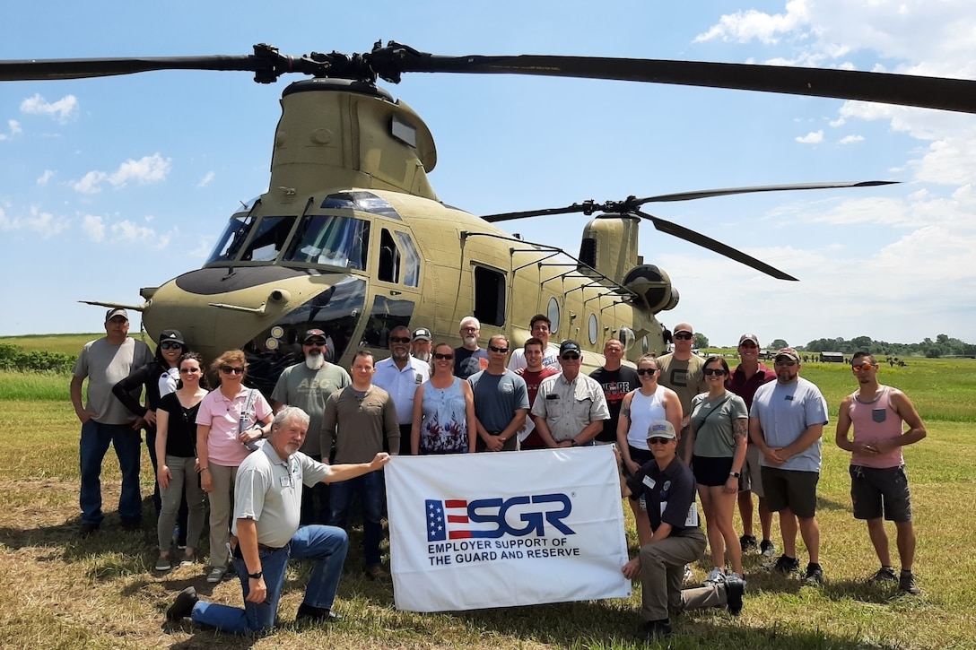 Civilian employers of Soldiers with the Nebraska Army National Guard's 2-134th Infantry Regiment (Airborne) pause for a photo following a ride on a CH-47 Chinook helicopter at the Mead Training Site near Yutan, Nebraska, June 11, 2022.