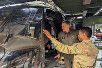 Capt. Diego Wilson, right, of the Eastern Army National Guard Aviation Training Site shows a maintenance training helicopter to Col. Antanas Matutis, commander of the Lithuanian Air Force, during a tour of the Aviation Maintenance Instructional Building at Fort Indiantown Gap, Pa., on March 23, 2023. (U.S. Air National Guard photo by Capt. Nathaniel Curtis)