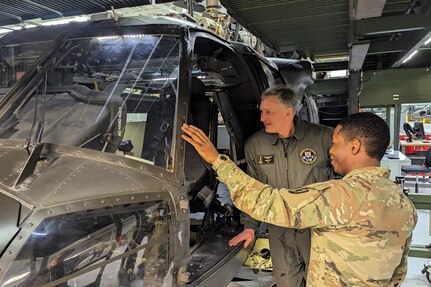 Capt. Diego Wilson, right, of the Eastern Army National Guard Aviation Training Site shows a maintenance training helicopter to Col. Antanas Matutis, commander of the Lithuanian Air Force, during a tour of the Aviation Maintenance Instructional Building at Fort Indiantown Gap, Pa., on March 23, 2023. (U.S. Air National Guard photo by Capt. Nathaniel Curtis)