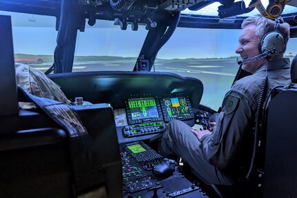 Col. Antanas Matutis, commander of the Lithuanian Air Force, receives an orientation and test drive of the Blackhawk Aircrew Trainer, a state-of-the-art rotary wing pilot simulator, at the Eastern Army National Guard Aviation Training Site at Fort Indiantown Gap, Pa., on March 23, 2023. (U.S. Air National Guard photo by Capt. Nathaniel Curtis)