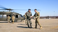 Lithuanian Air Force Col. Antanas Matutis, left, Lithuanian Air Force Commander, is greeted by U.S. Air National Guard Col. Deane E. Thomey, Commander, 111th ATKW, after arriving here in a UH-60 Blackhawk during a visit to Biddle Air National Guard Base in Horsham, Pennsylvania, Mar. 20, 2023. Matutis, and his senior enlisted leader, Command Sgt. Maj. Alvydas Tamošiūnas, were visiting Biddle ANG Base as part of a broader National Guard State Partnership Program (NG SPP) tour hosted by the Commander of the PAANG, Brig. Gen. Michael Regan. Pennsylvania and Lithuania have been partners under this program since April 27, 1993. (U.S. Air National Guard photo by Staff Sgt. Wilfredo Acosta)