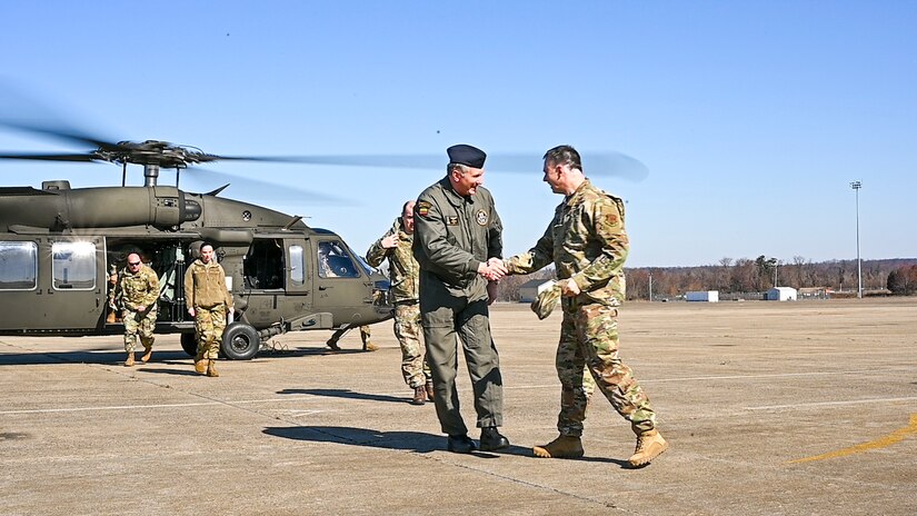 Lithuanian Air Force Col. Antanas Matutis, left, Lithuanian Air Force Commander, is greeted by U.S. Air National Guard Col. Deane E. Thomey, Commander, 111th ATKW, after arriving here in a UH-60 Blackhawk during a visit to Biddle Air National Guard Base in Horsham, Pennsylvania, Mar. 20, 2023. Matutis, and his senior enlisted leader, Command Sgt. Maj. Alvydas Tamošiūnas, were visiting Biddle ANG Base as part of a broader National Guard State Partnership Program (NG SPP) tour hosted by the Commander of the PAANG, Brig. Gen. Michael Regan. Pennsylvania and Lithuania have been partners under this program since April 27, 1993. (U.S. Air National Guard photo by Staff Sgt. Wilfredo Acosta)