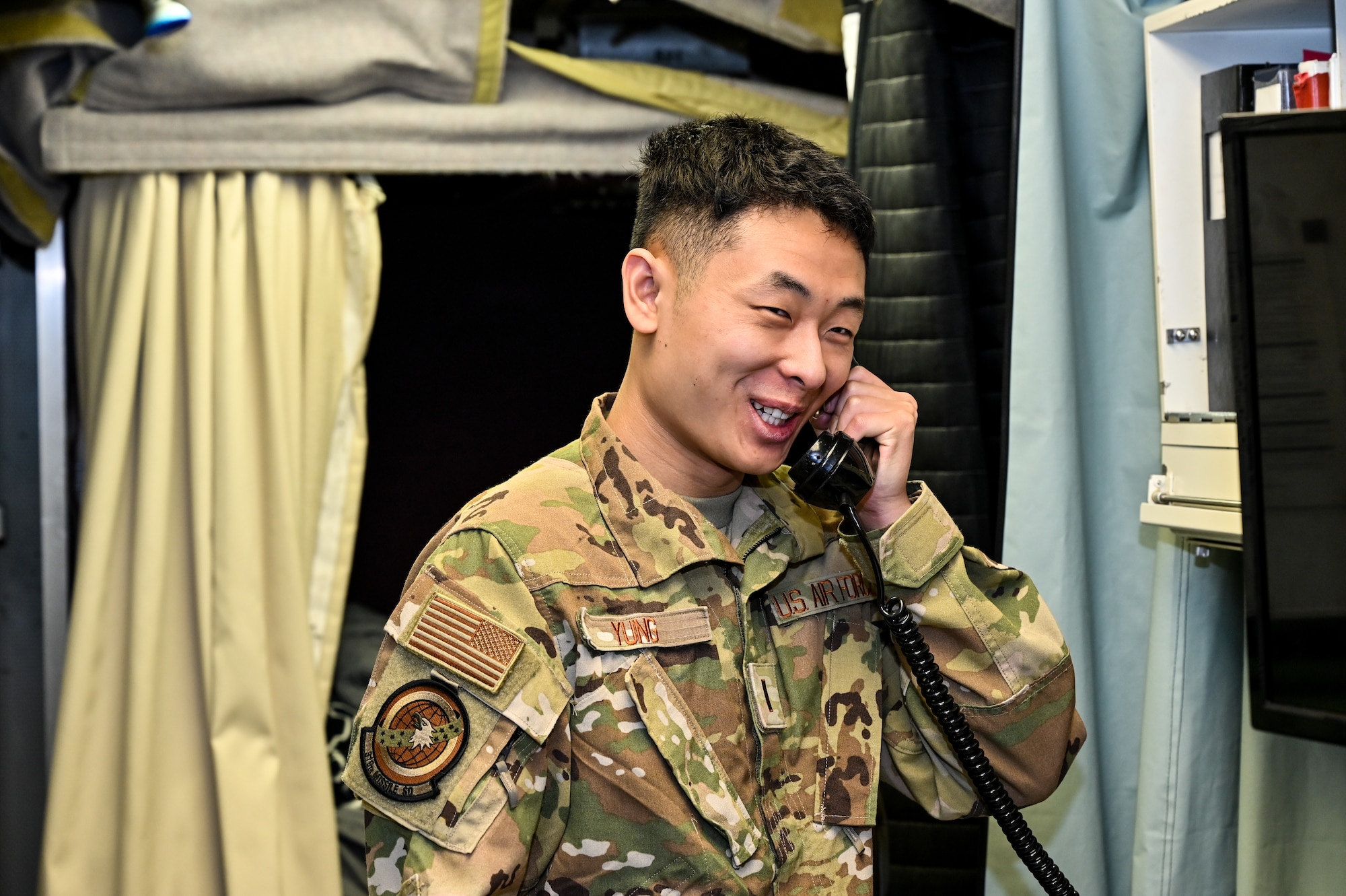 2nd Lt. Zheng Jung, 319th Missile Squadron missileer, responds to a call after a team from the Nebraska Department of Economic Development and civic leaders from Kimball and Sidney, Nebraska, visited the C-01 missile alert facility near Harrisburg, Nebraska, March 22, 2023. 319 MS educated them on the safe, secure and reliable operation of the Minuteman III system.  (U.S. Air Force photo by Joseph Coslett Jr.)