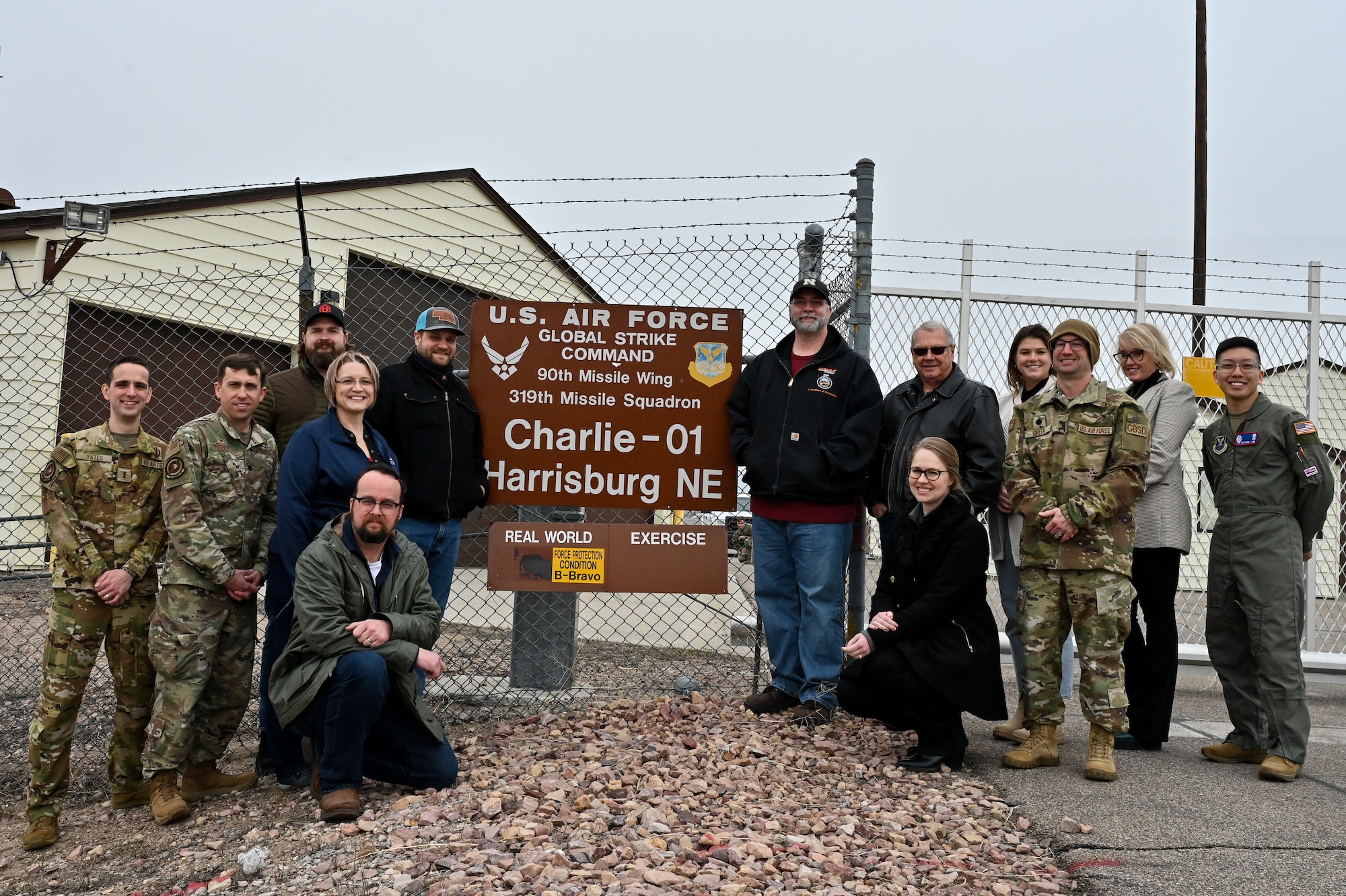 A team from the Nebraska Department of Economic Development and civic leaders from Kimball and Sidney, Nebraska, pose for a photo outside the C-01 missile alert facility near Harrisburg, Nebraska, March 22, 2023. The 319th Missile Squadron educated them on the safe, secure and reliable operation of the Minuteman III system. (U.S. Air Force photo by Joseph Coslett Jr.)