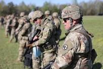 Sgt. 1st Class Martin Baumgardner lines up with Soldiers from the 84th Training Command preparing to engage in fires with their 100 meter targets during the ALL-ARMY Small Arms Competition.