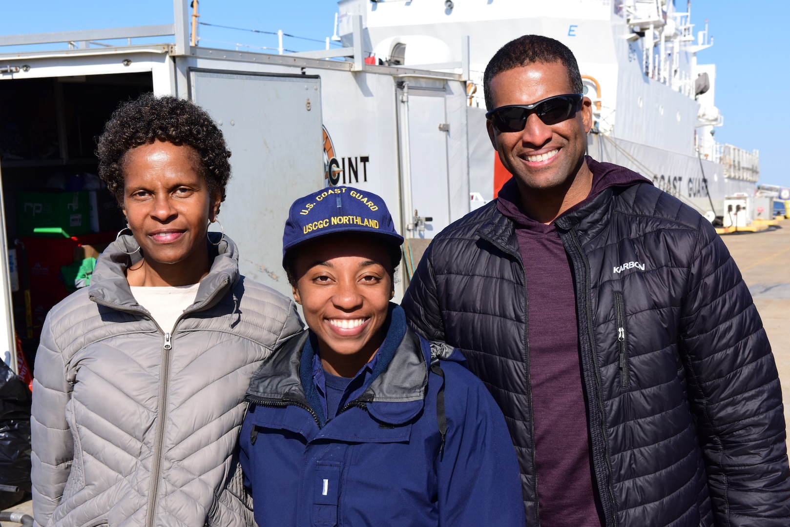 Lt. j.g. Briana Willis poses for a photo with loved ones after the USCGC Northland (WMEC 904) returned home, March 30, 2023 in Portsmouth, Virginia. Northland conducted a 62-day maritime safety and security deployment in the Florida Straits and Windward Passage while patrolling in support of Homeland Security Task Force – Southeast and Operation Vigilant Sentry. (U.S. Coast Guard photo by Petty Officer 2nd Class Brandon Hillard)