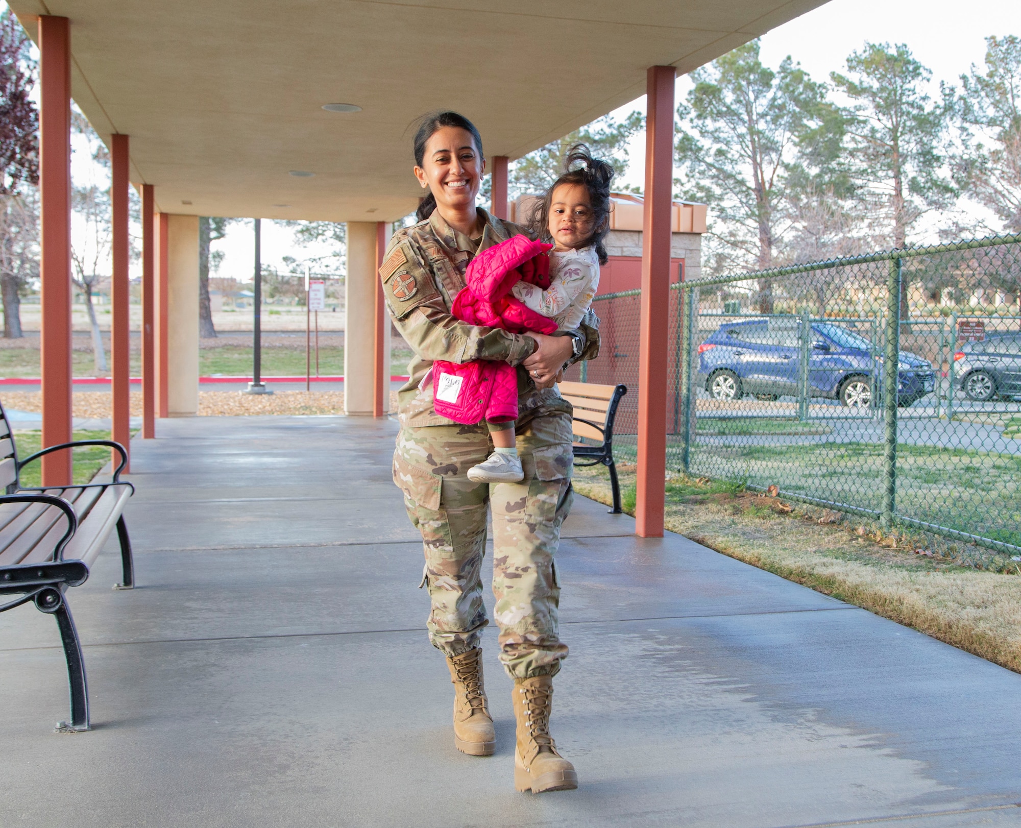 Maj. Meshva Akwalia, 412th Medical Group, drops off her daughter at the child development center. Quality childcare facilities and a wide variety of programs have distinguished the Edwards CDC as a flagship for childcare in Air Force Materiel Command. (Air Force photo by Todd Schannuth)