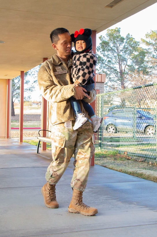Senior Airman Justin Delos Santos, 412th Medical Group, drops off his daughter at the child development center. The Child Development Center cares for children ages 6 weeks to 5 years, with a DOD-wide curriculum. The curriculum is focused on learning through play activities supporting social, emotional, physical and intellectual development. Installations across DOD follow the curriculum on the same timeline to allow seamless permanent change-of-station transitions for youth enrolled in care. (Air Force photo by Todd Schannuth)