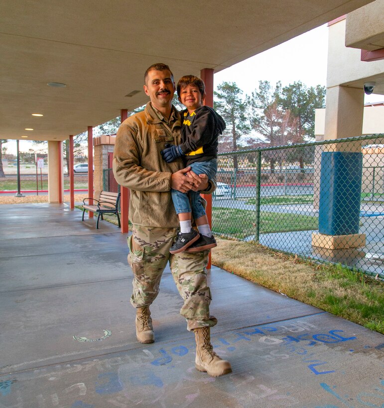 Master Sgt. Robert Pulido, 412th Maintenance Group drops off his son at the child development center. Op-quality childcare has been a priority at Edwards for many years as evidenced by the quality facilities and the wide variety of programs offered and the recent expansion of available slots for children. Ongoing efforts focus on further expansion through existing projects and securing additional project and program funds for our centers. (Air Force photo by Todd Schannuth)