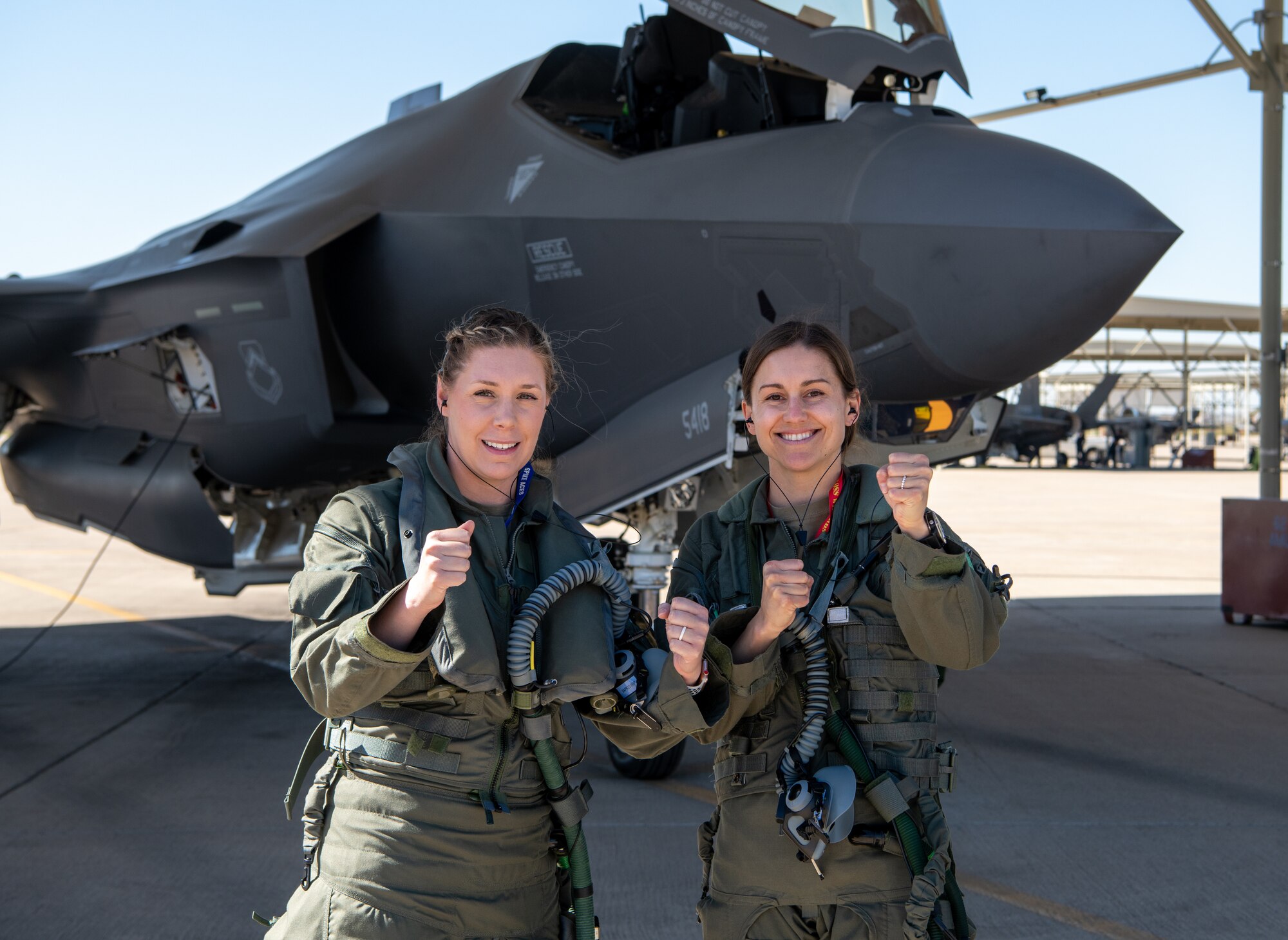 U.S. Air Force Capt. Sara Eagle (left), F-35 student pilot and U.S. Air Force Capt. Melanie Kluesner (right), 62nd Fighter Squadron F-35 instructor pilot, pose for a photo before a sortie at Luke Air Force Base, Arizona, Mar. 28, 2023.
