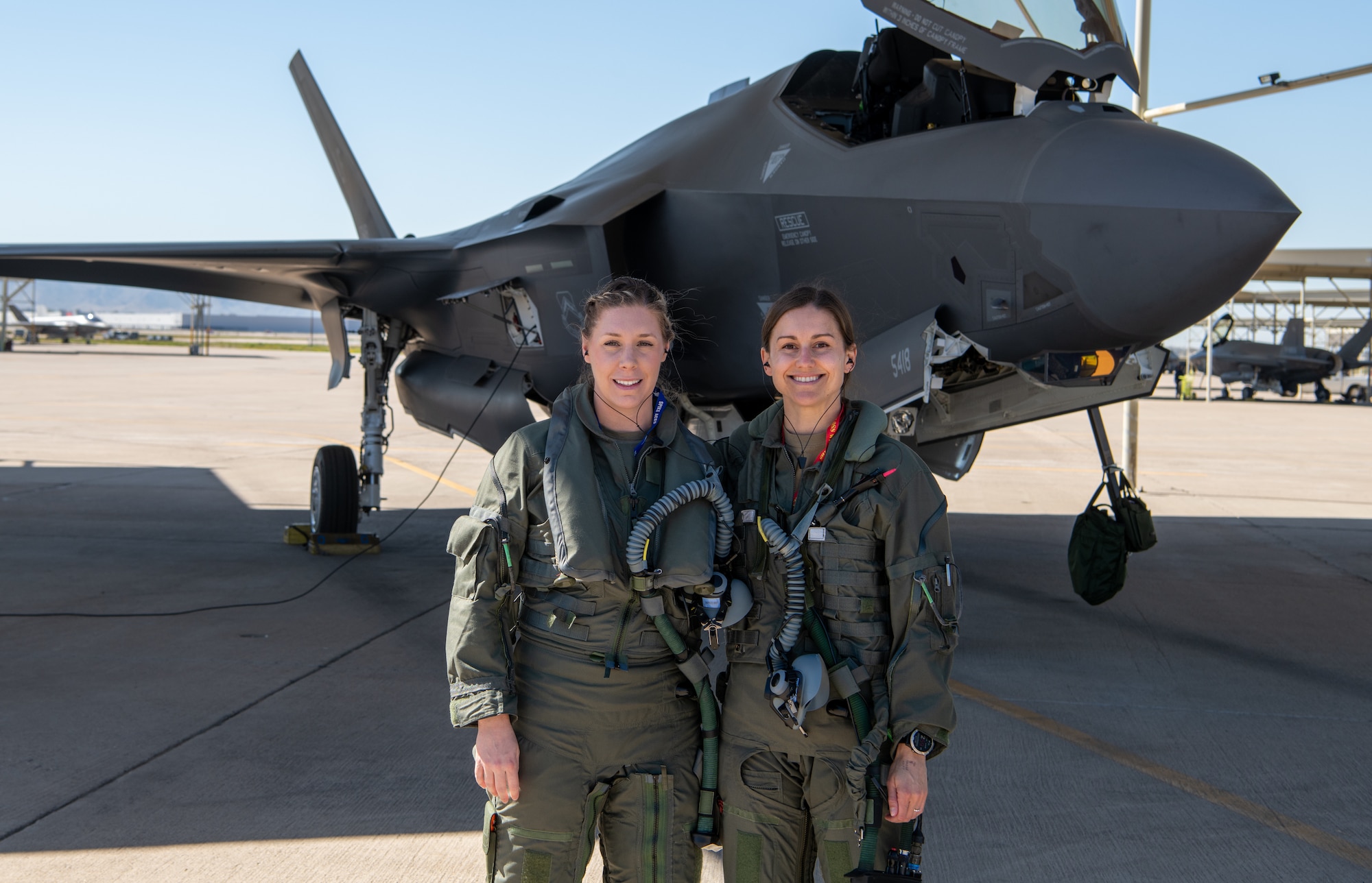 U.S. Air Force Capt. Sara Eagle (left), F-35 student pilot and U.S. Air Force Capt. Melanie Kluesner (right), 62nd Fighter Squadron F-35 instructor pilot, pose for a photo before a sortie at Luke Air Force Base, Arizona, Mar. 28, 2023.