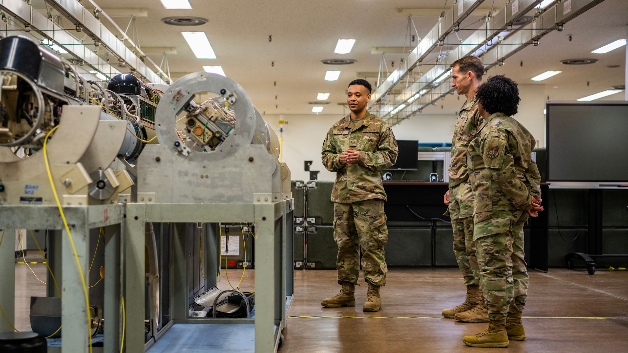 U.S. Air Force Staff Sgt. Lorenzo Finch, 35th Maintenance Squadron electronic warfare systems craftsman, explains aircraft systems to Col. Michael Richard, 35th Fighter Wing (FW) commander, and Command Chief Master Sgt. Cheronica Blandburg, 35th FW command chief, during a Wild Weasel Walk-through at Misawa Air Base, Japan, March 30, 2023. Electronic warfare systems specialists go through extensive training to be able to install and service radar, communications, weapons and other flight operations to ensure the safety of the aircraft and the crew and the successful completion of missions. (U.S. Air Force photo by Tech. Sgt. Jao’Torey Johnson)