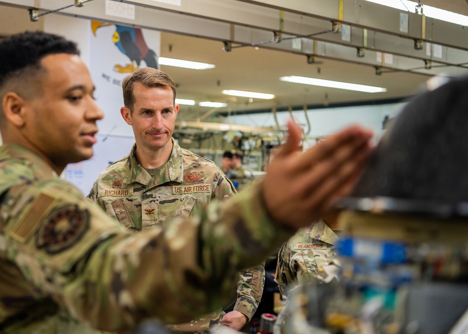 U.S. Air Force Staff Sgt. Lorenzo Finch, 35th Maintenance Squadron electronic warfare systems craftsman, explains aircraft systems to Col. Michael Richard, 35th Fighter Wing (FW) commander, and Command Chief Master Sgt. Cheronica Blandburg, 35th FW command chief, during a Wild Weasel Walk-through at Misawa Air Base, Japan, March 30, 2023. Electronic warfare systems specialists go through extensive training to be able to install and service radar, communications, weapons and other flight operations to ensure the safety of the aircraft and the crew and the successful completion of missions. (U.S. Air Force photo by Tech. Sgt. Jao’Torey Johnson)