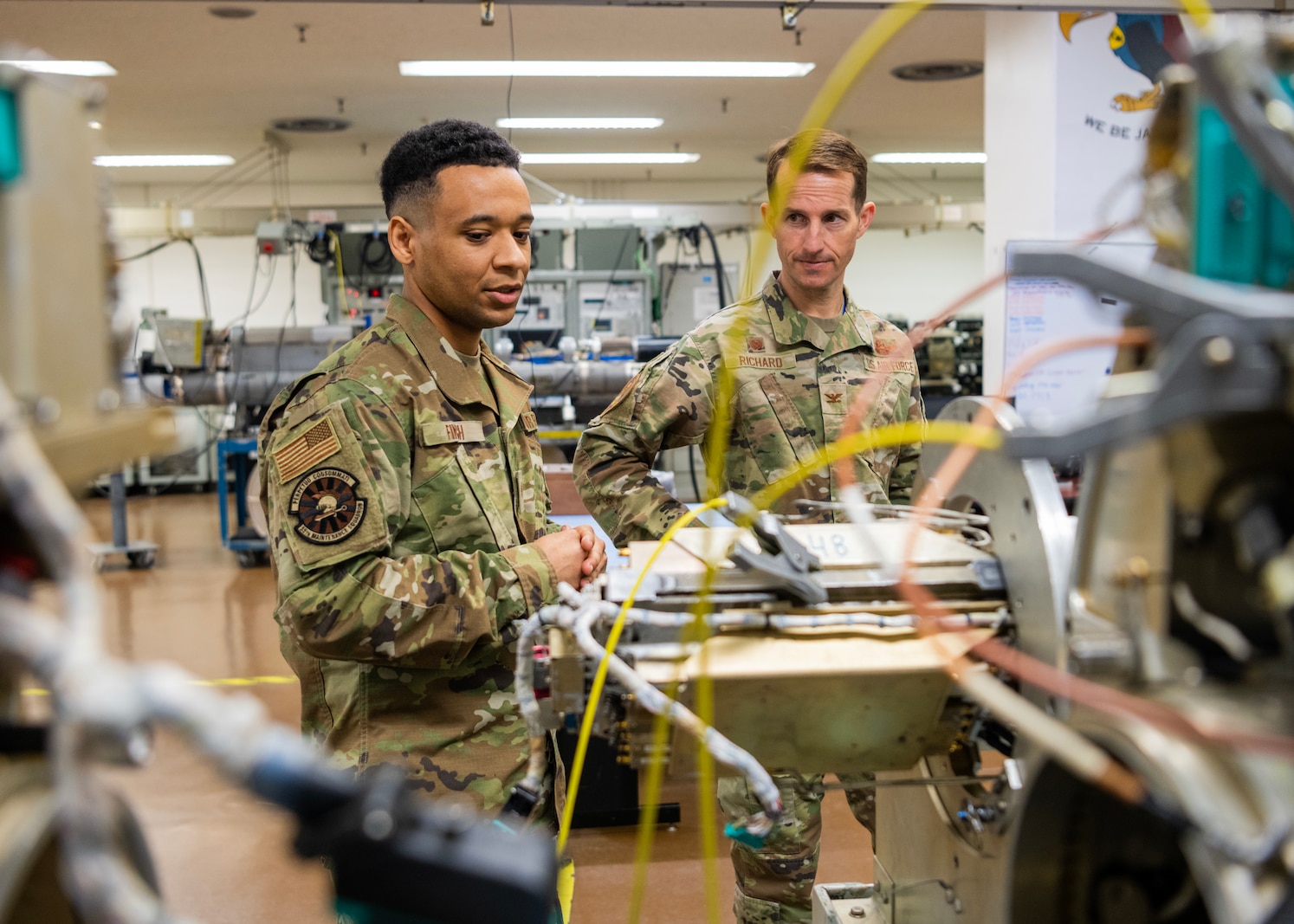 U.S. Air Force Staff Sgt. Lorenzo Finch, 35th Maintenance Squadron electronic warfare systems craftsman, explains aircraft systems to Col. Michael Richard, 35th Fighter Wing (FW) commander, and Command Chief Master Sgt. Cheronica Blandburg, 35th FW command chief, during a Wild Weasel Walk-through at Misawa Air Base, Japan, March 30, 2023. Electronic warfare systems specialists go through extensive training to be able to install and service radar, communications, weapons and other flight operations to ensure the safety of the aircraft and the crew and the successful completion of missions. (U.S. Air Force photo by Tech. Sgt. Jao’Torey Johnson)