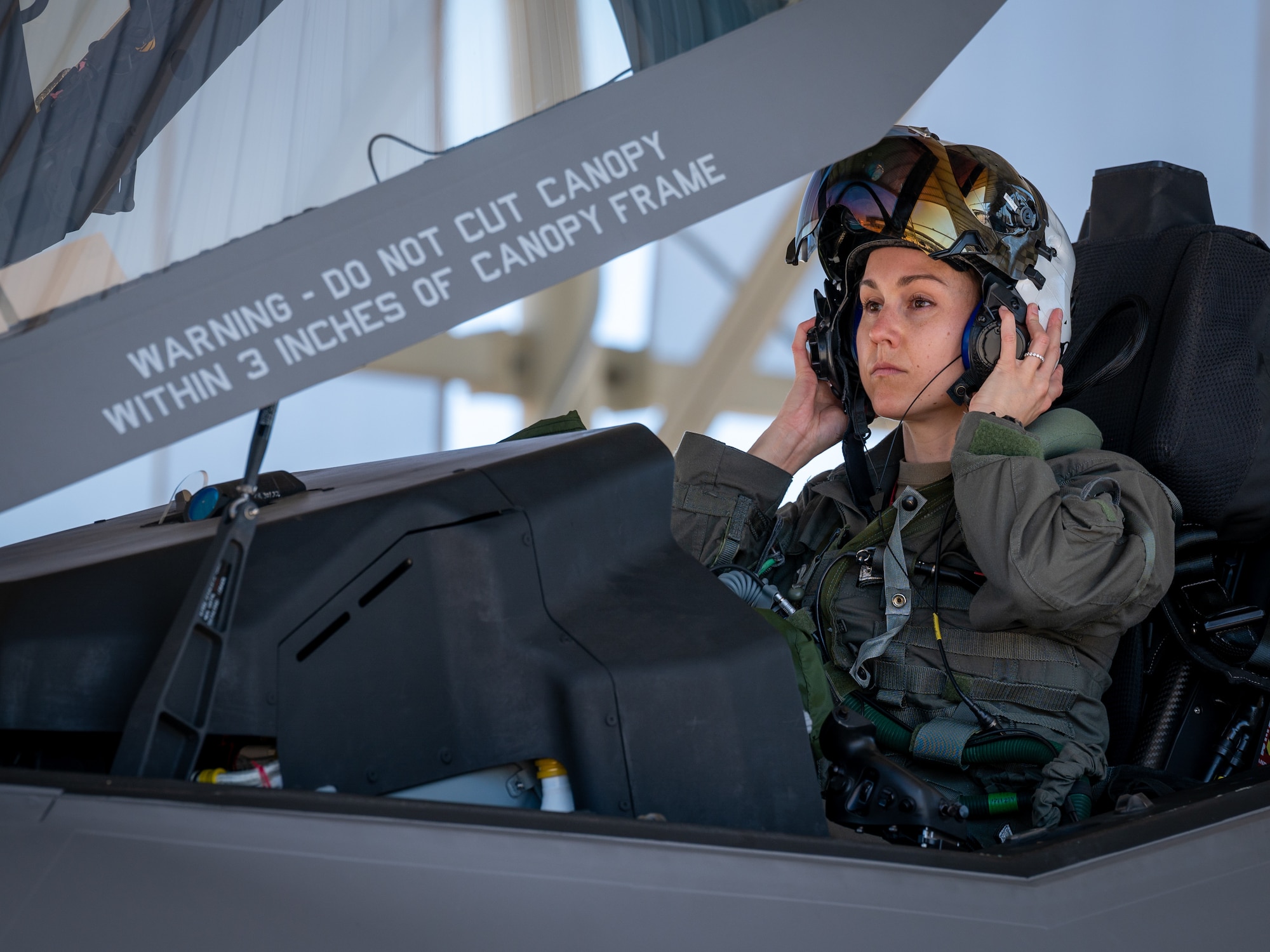U.S. Air Force Capt. Melanie Kluesner, 62nd Fighter Squadron F-35 Lightning II instructor pilot, secures her helmet before take-off March 28, 2023, at Luke Air Force Base, Arizona.