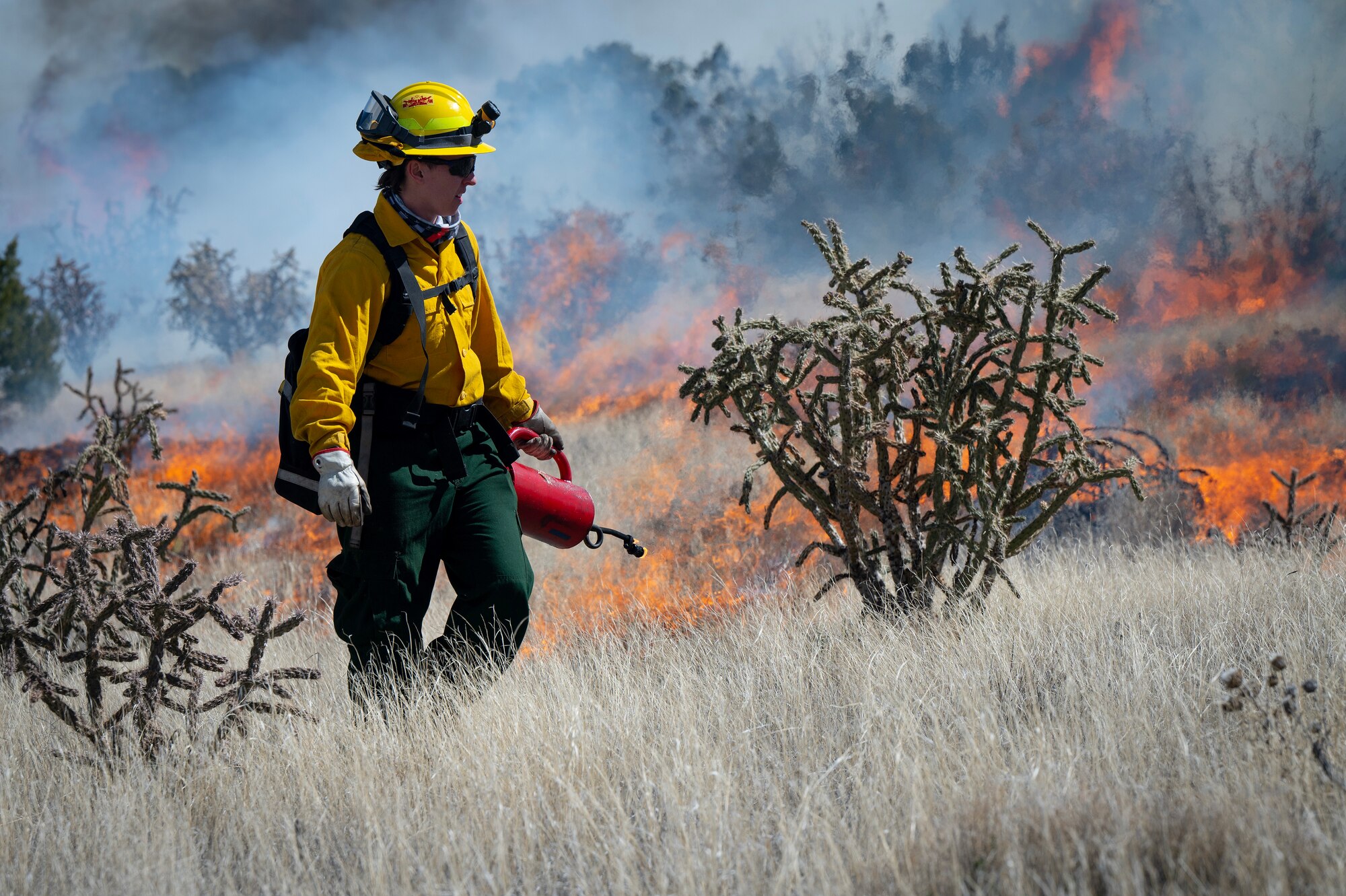 A man starts controlled fire.