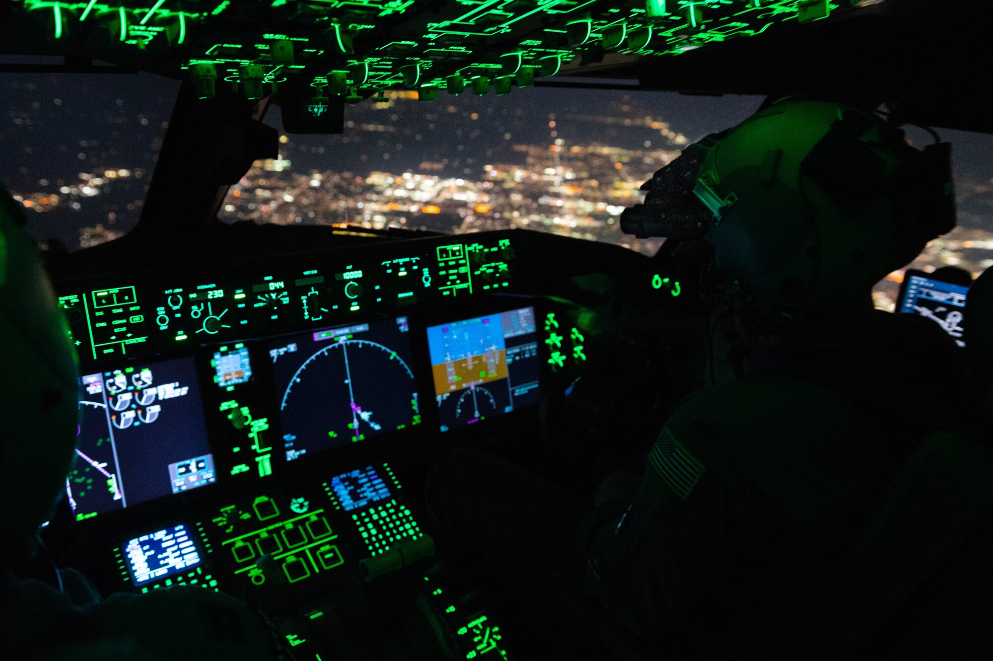 Capt. Adam Scott, 344th Air Refueling Squadron copilot, pilots a KC-46A Pegasus over Kansas March 29, 2023, during Exercise Lethal Pride. The aircrew utilized night vision goggles to perform the first training on the newly installed Airfield Marking Patterns (AMP)-3 system at McConnell Air Force Base, Kan. AMP-3 is a specific type of airfield marking pattern that is used for unconventional airfields and landing zones that lack traditional airfield lighting. (U.S. Air Force photo by Airman 1st Class Brenden Beezley)