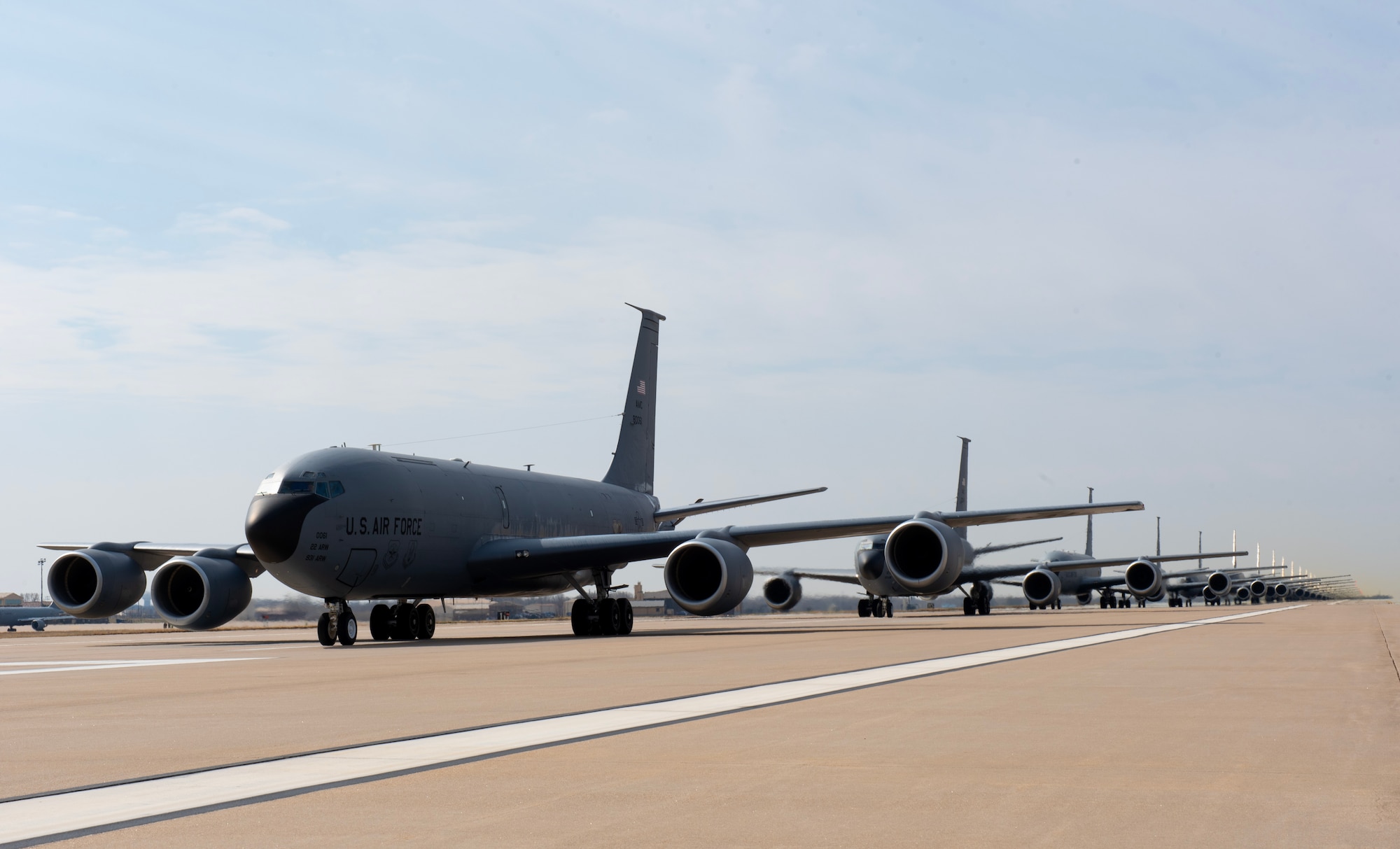 Sixteen KC-46 Pegasus and five KC-135 Stratotankers perform an elephant walk during Exercise Lethal Pride at McConnell Air Force Base, Kansas, March 27, 2023. After the elephant walk the aircraft participated in an aircraft flush where they all took off in rapid succession. (U.S. Air Force photo by Staff Sgt. Tryphena Mayhugh)