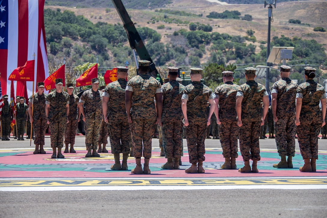 U.S. Marines with the School of Infantry - West, stand at attention during a change of command ceremony at SOI-West on Marine Corps Base Camp Pendleton, California, June 24, 2022. During the ceremony, Col. Coby Moran relinquished command of SOI-West to Col. Seth MacCutcheon. (U.S. Marine Corps photo by Cpl. Alison Dostie)