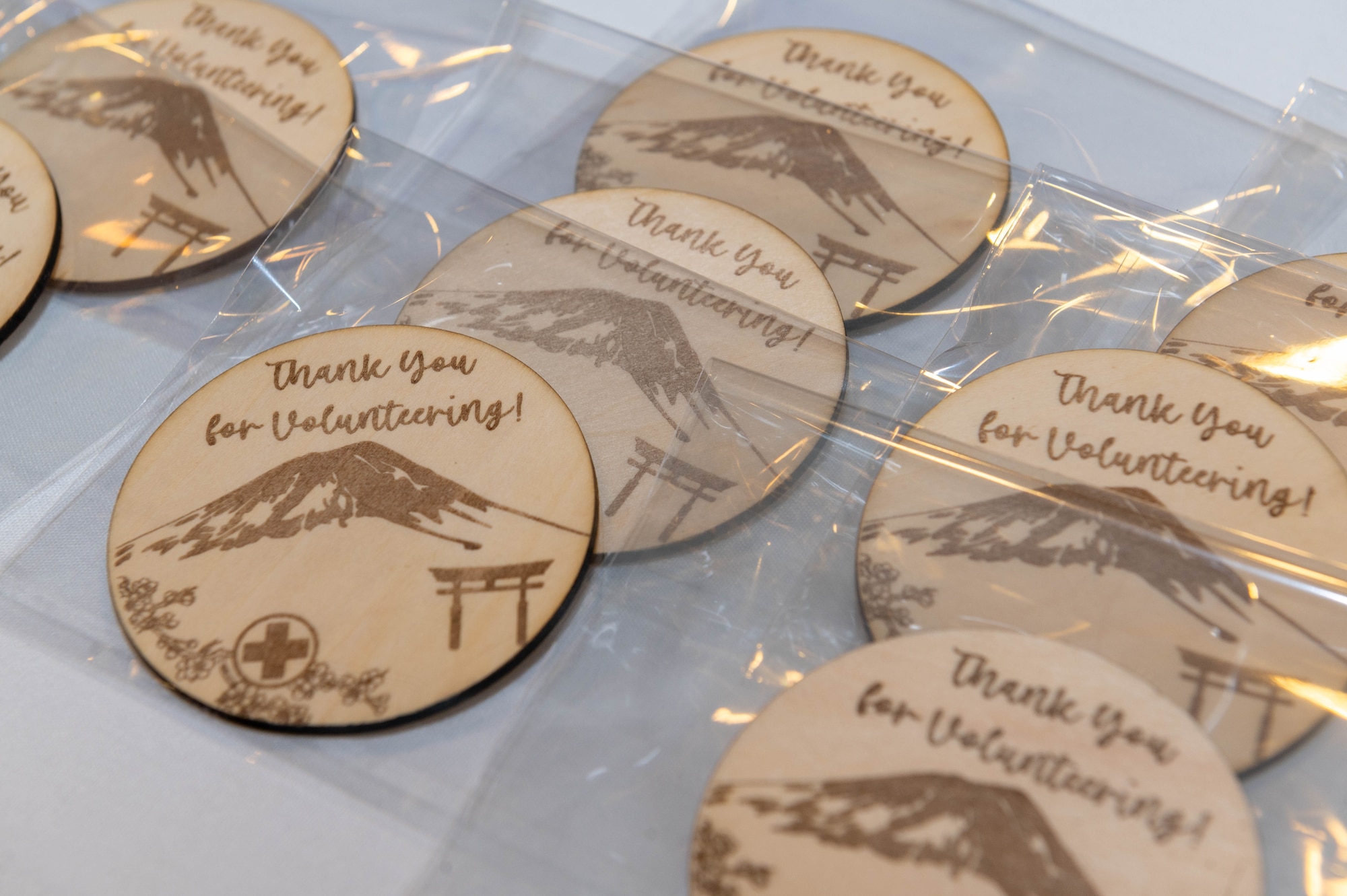 Wooden badges rest on a table.