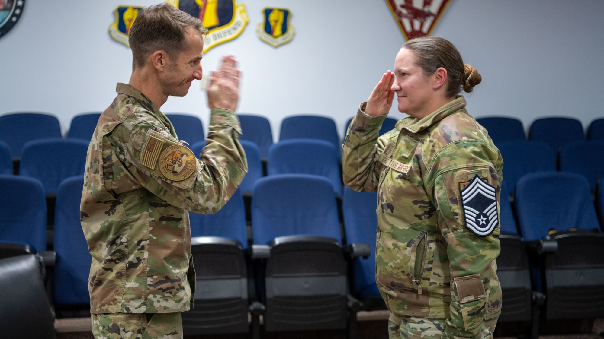 U.S. Air Force Senior Master Sgt. Diana Rogers, 35th Civil Engineer Squadron explosive ordnance disposal superintendent, salutes Col. Michael Richard, 35th Fighter Wing commander, during a chief master sergeant release ceremony at Misawa Air Base, Dec. 1, 2022. Air Force officials selected 514 senior master sergeants for promotion to chief master sergeant for the 22E9 promotion cycle. (U.S. Air Force photo by Staff Sgt. Kristen Heller)