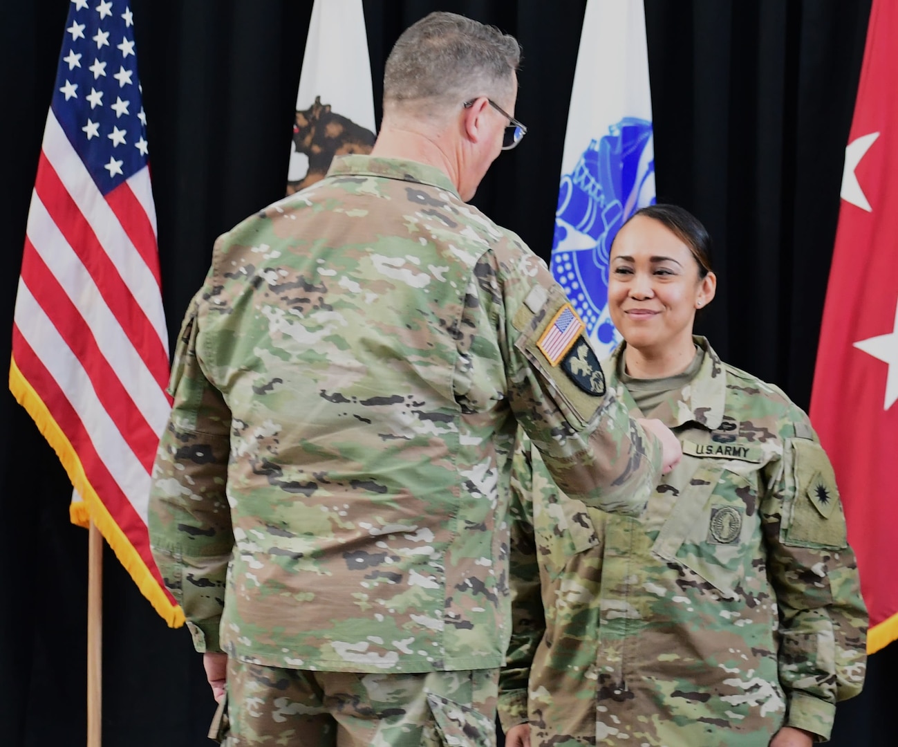 Maj. Gen. Matthew P. Beevers, the acting adjutant general of the California National Guard, pins the rank of brigadier general to Brig. Gen. Marlena A. DeCelle's uniform at her promotion ceremony in Sacramento, California, Jan. 26, 2023.
