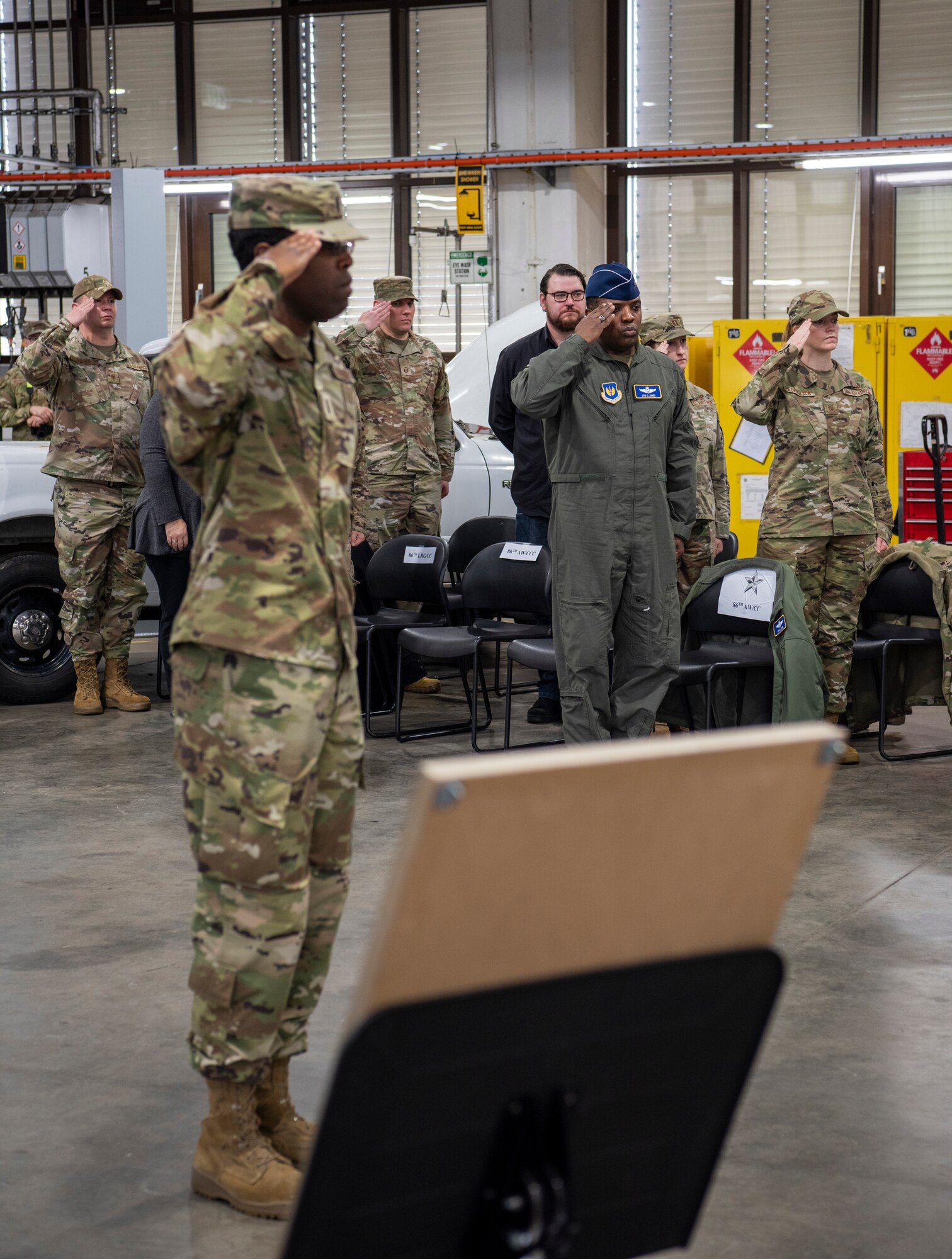 Airmen salute photo during a ceremony.