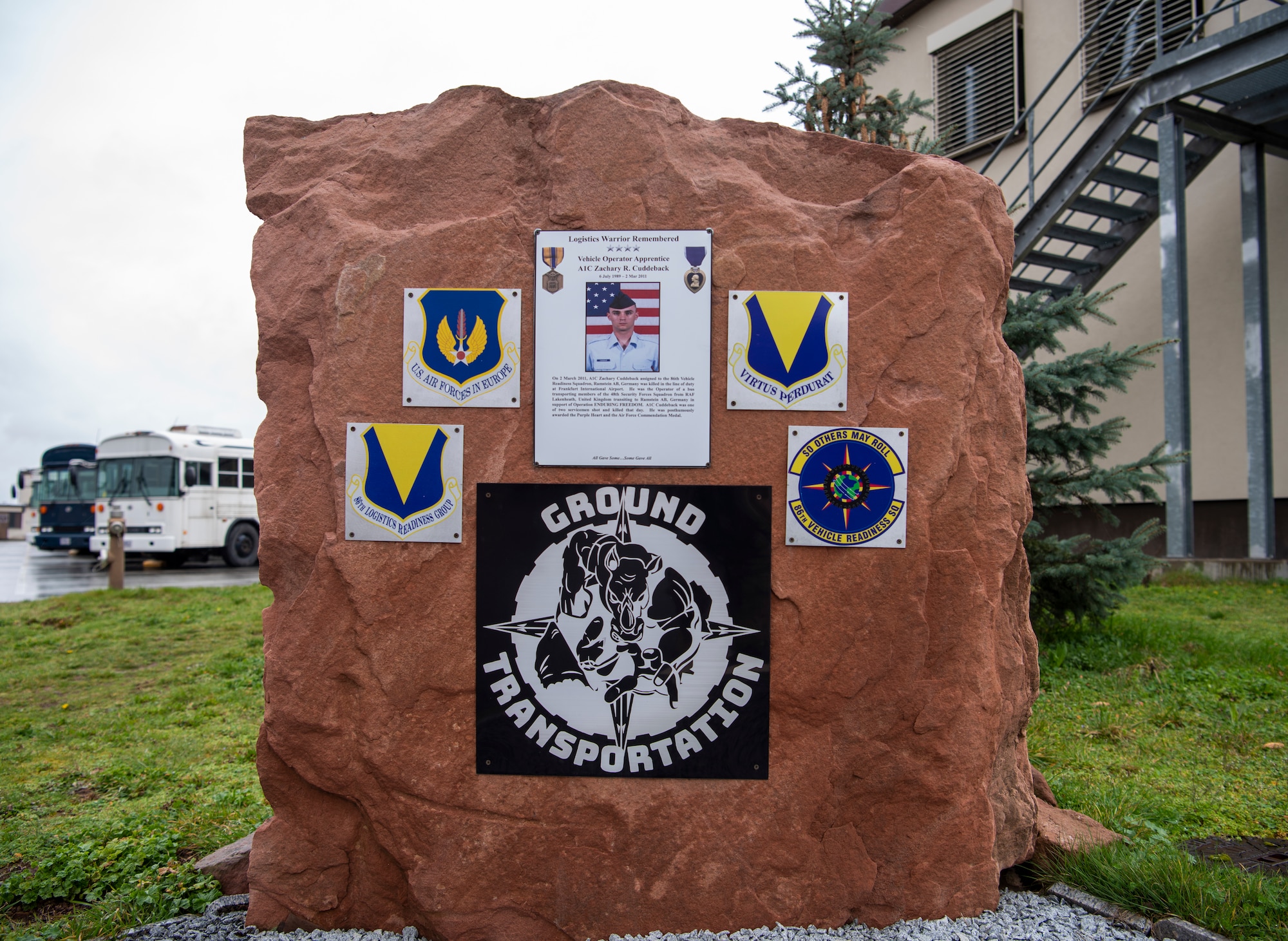 A memorial stands in front a building