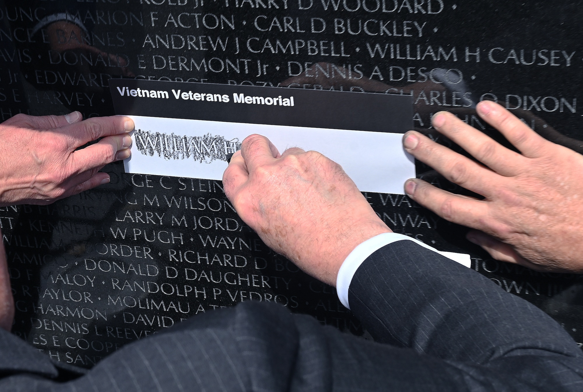 Secretary of the Air Force Frank Kendall etches a name during a visit the Vietnam War Memorial, Washington, D.C., March 29, 2023. Department of the Air Force senior leaders visited to pay their respects to the deceased service members killed in action during the Vietnam War on National Vietnam War Veteran’s Day. (U.S. Air Force photo by Staff Sgt. Chad Trujillo)