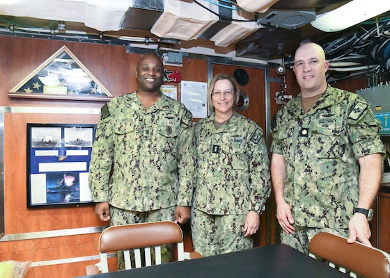 NORFOLK (Sept. 14, 2022) Command Master Chief Joseph Williamson, Chief of the Boat, USS New Mexico (SSN 779), Vice Adm. Kelly Aeschbach, Commander, Naval Information Forces and Executive Officer LCDR Douglas K. McKenzie, USS New Mexico (SSN 779) pose for a photo during a tour of the submarine. The USS New Mexico (SSN 779) is a Virginia-class attack submarine which is also known as the VA-class or 774-class, a class of nuclear-powered fast attack submarines. USS New Mexico is one of two SSNs participating in the Information Warfare (IW) Pilot program, which assigns IW officers and Sailors about the SSNs to pilot close integration and employment of IW on these platforms. (U.S. Navy Photo by Robert Fluegel / Released)