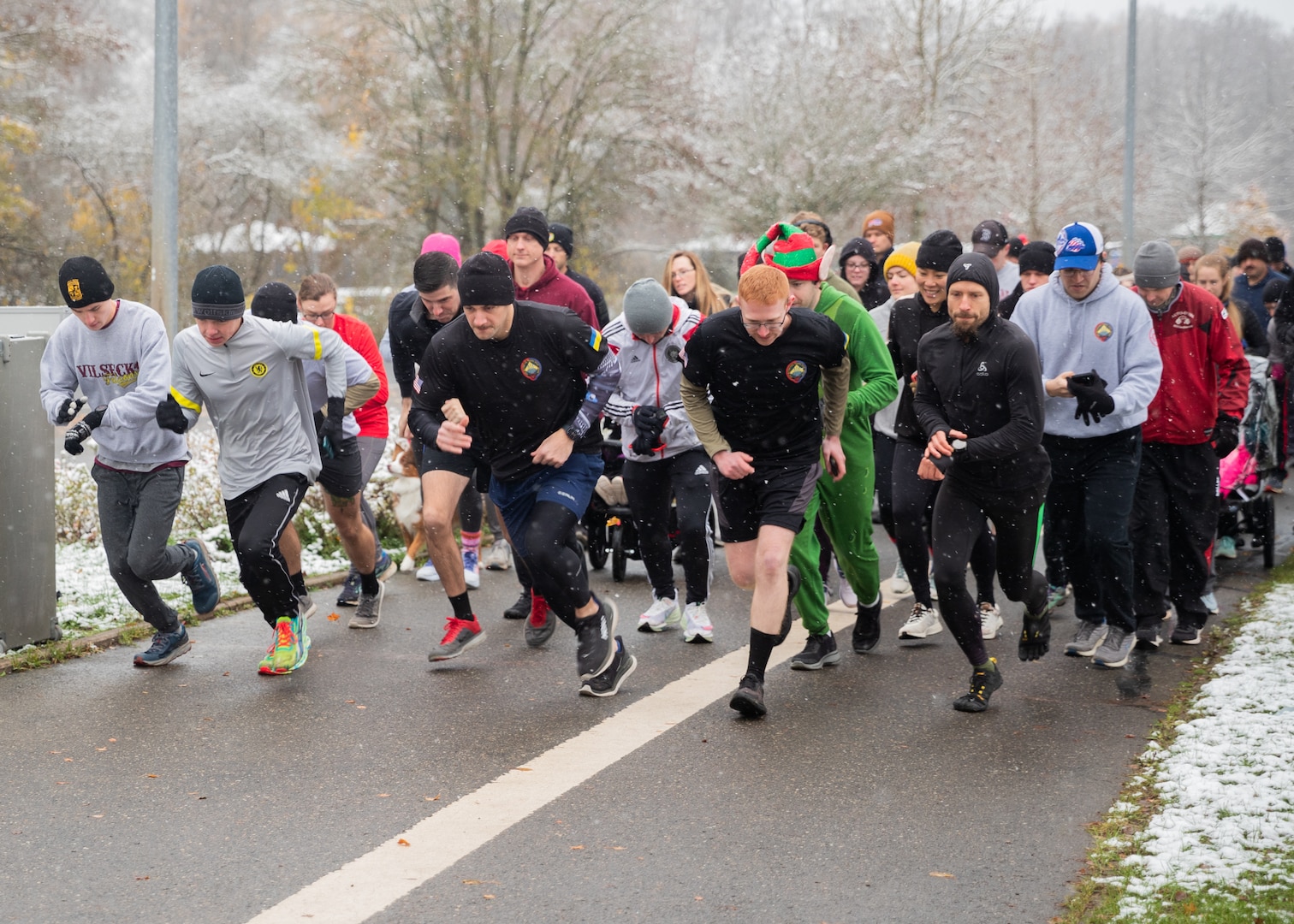 U.S. Army Soldiers assigned to Task Force Orion, 27th Infantry Brigade Combat Team, New York Army National Guard, run alongside Soldiers, civilians and family members in a 5K “Turkey Trot” fun run at Rose Barracks in Grafenwoehr, Germany, Nov. 19, 2022. U.S. Army Garrison Bavaria holds the annual event to boost morale and promote physical fitness before the Thanksgiving holiday.