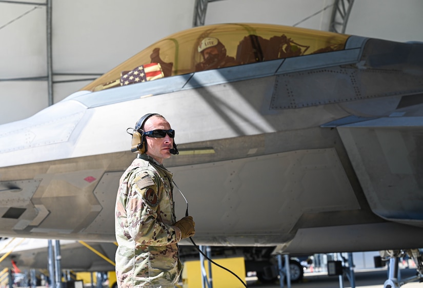 Crew chief awaits to communicate to the pilot