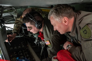 Master Sgt. Kyle McCormick shows Col. Antanas Matutis what an aerial refueling mission looks like from the refueling pod