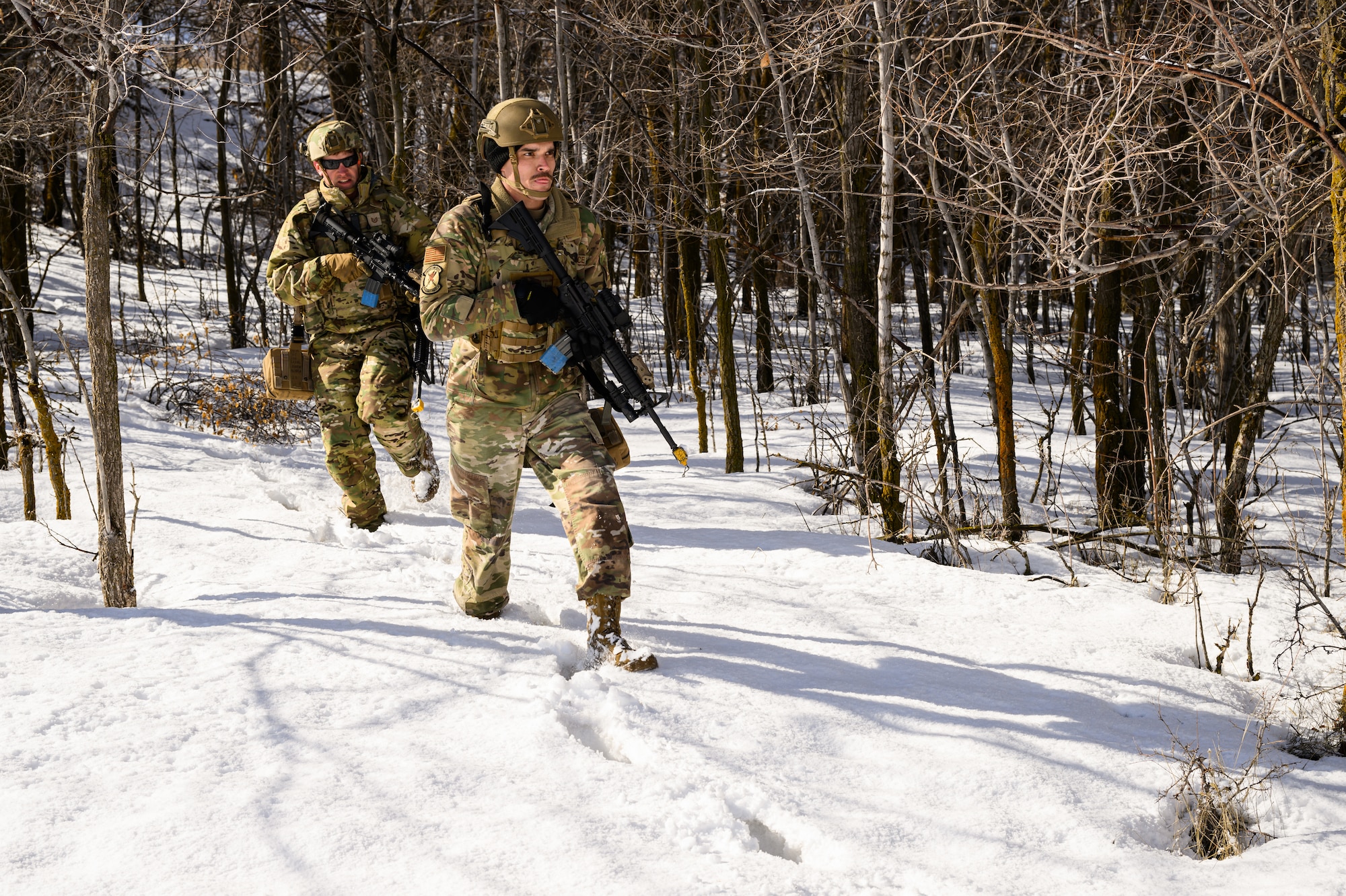 Right, Staff Sgt. Brandon Stoker and Tech. Sgt. Andrew Lintelman, 75th Security Forces Squadron, search for opposing forces during a training exercise at Hill Air Force Base, Utah, March 21, 2023. The squadron conducted a series of near-peer adversary field training exercises in the Base Operations Readiness Area from March 18-28. (U.S. Air Force photo by R. Nial Bradshaw)
