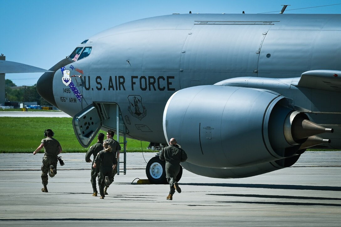 Airmen from the 155th Air Refueling Wing run towards their KC-135R Stratotanker, May 13, 2022, during a generation exercise at Lincoln Air Force Base, Neb.