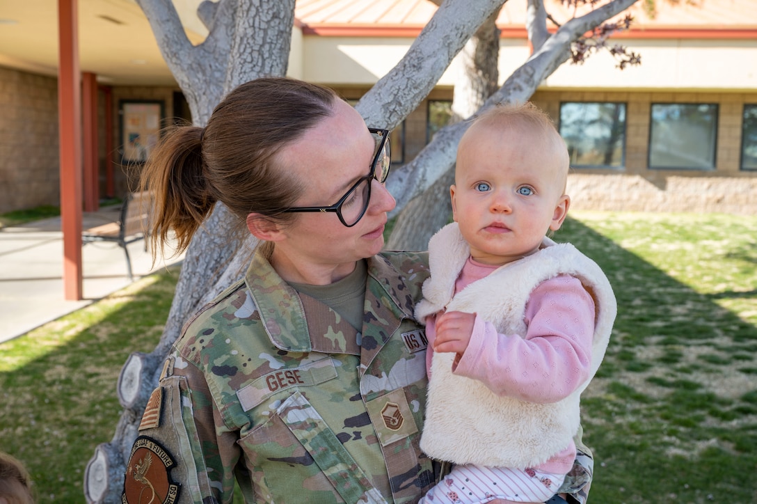 Master Sgt. Erica Gese, 412th Operations Support Squadron picks up her daughter at the child development center. Quality childcare facilities and a wide variety of programs have distinguished the Edwards CDC as a flagship for childcare in the Air Force Materiel Command.