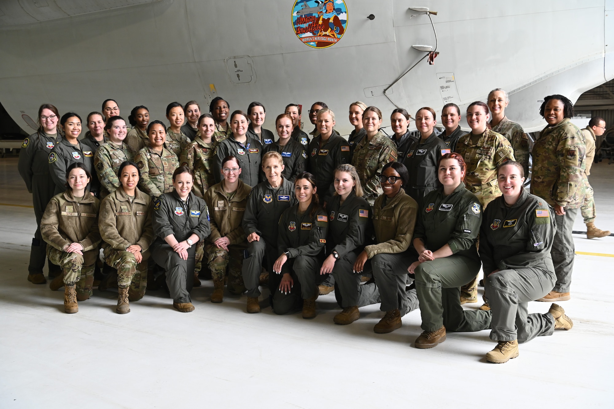 Female Airmen posing for group photo in front of E-3G aircraft