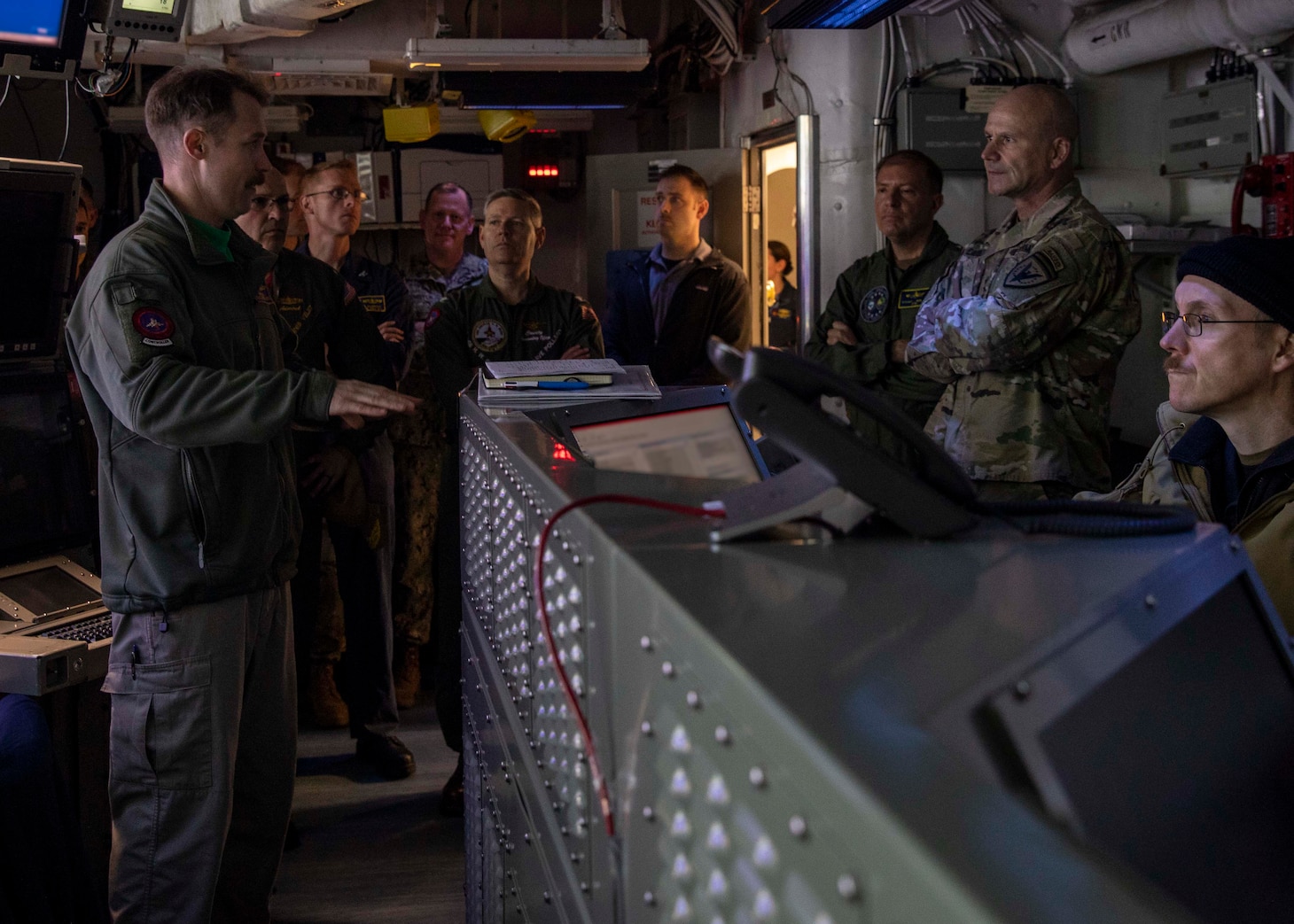 U.S. Army Gen. Christopher Cavoli, Supreme Allied Commander Europe (SACEUR) and commander, U.S. European Command, right, and Adm. Stuart Munsch, commander, Allied Joint Force Command Naples, and commander, U.S. Naval Forces Europe-Africa, center right, are briefed on daily operations by Lt. Cmdr. Mike Shea, Task Force Command-and-Control office for Carrier Strike Group (CSG) 10, aboard the Nimitz-class aircraft carrier USS George H.W. Bush (CVN 77), March 24, 2023.