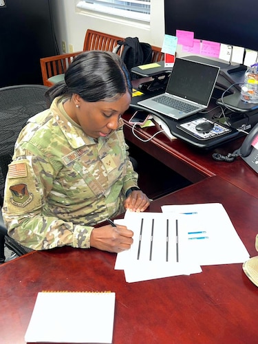 Senior Airman Kenia Sinclair, religious affairs Airman, works on documents at the 628th Air Base Wing Chapel, Joint Base Charleston, S.C., March 26, 2023. Sinclair moved to America in 1999 from Jamaica and joined the U.S. Air Force in 2020 as a way of giving back to the country that made so many of her dreams possible such as competing in four Olympic games. (U.S. Air Force courtesy photo)