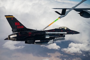 F-16 Fighting Falcon assigned to the 64th Aggressor Squadron receives fuel from a KC-135R Stratotanker