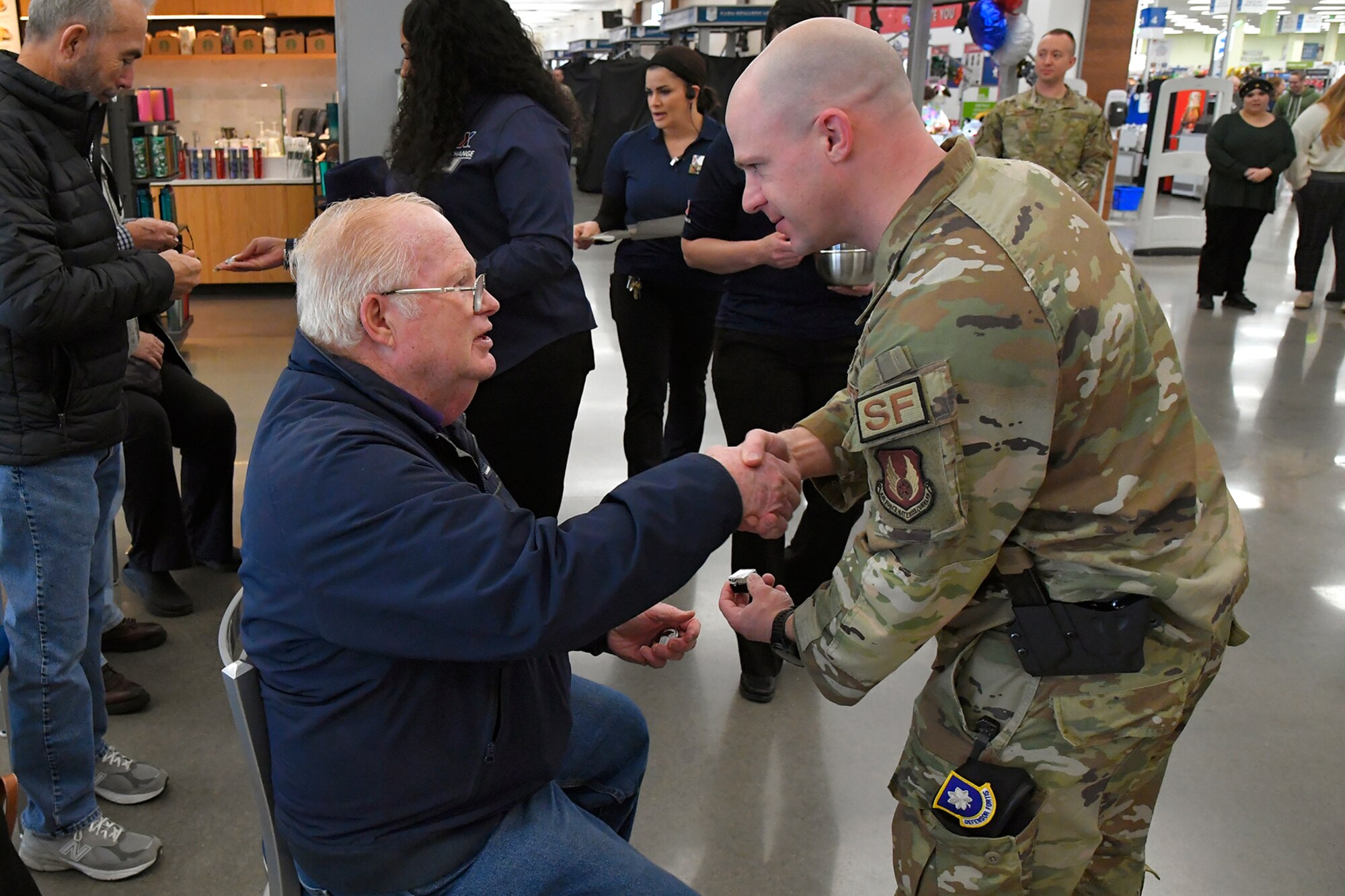 (Left to right) Bill Moran, a Vietnam veteran who served in the Air Force for 22 years, receives a commemorative lapel pin from Lt. Col. Paul Dinkins, 75th Security Forces Squadron commander, during a pinning ceremony March 29, 2023, at the AAFES Base Exchange at Hill Air Force Base, Utah. The ceremony was held to honor and remember Vietnam era veterans for National Vietnam Veterans Day. (U.S. Air Force photo by Todd Cromar)