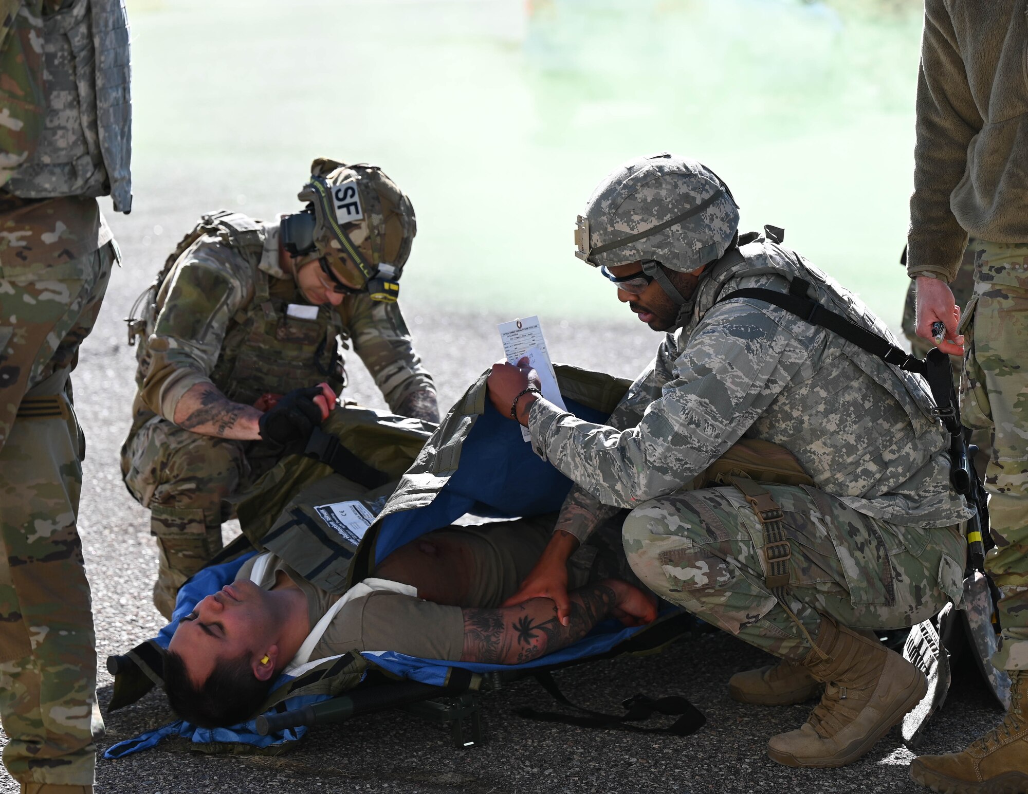 Airmen check vitals on patient