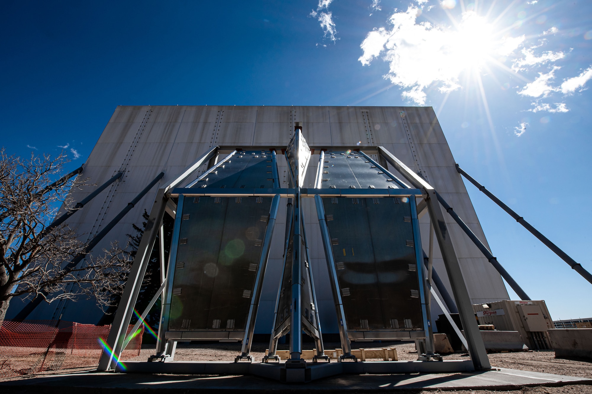 Contractors display the aluminum water barrier in front of a white structure that houses the U.S. Air Force Academy's Cadet Chapel.