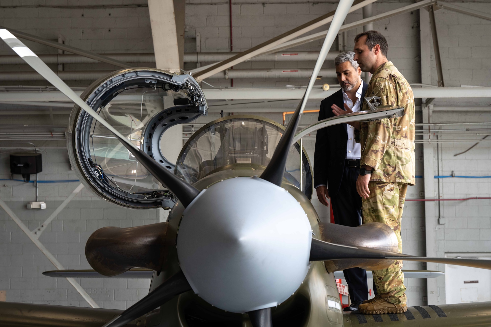 President Mario Abdo Benítez of the Republic of Paraguay views a A-29 display while an AFSOC Airman with the 18th Special Operations Test and Evaluation Squadron explains the aircraft’s mission at Hurlburt Field, Fla., March 31, 2023.