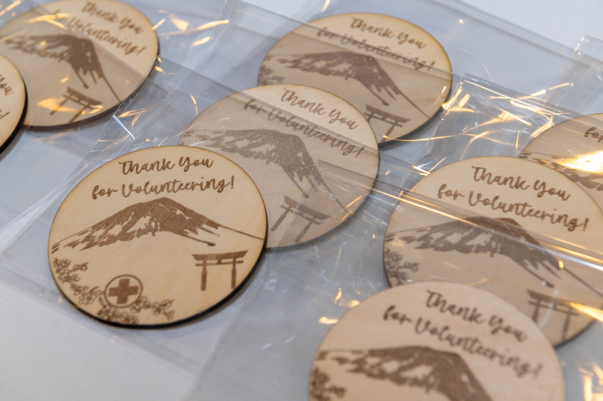 Wooden badges rest on a table.